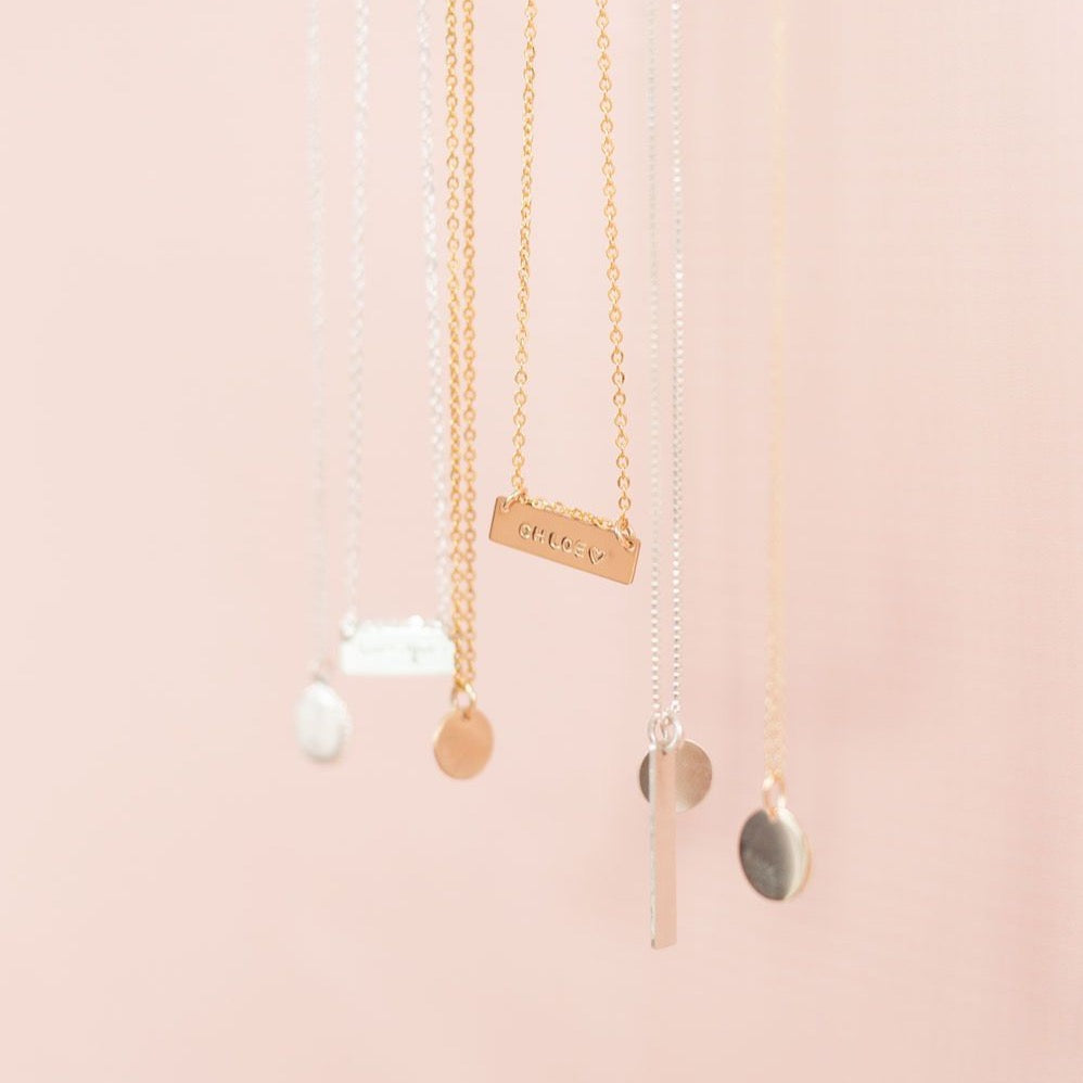 Variety of custom handmade coin and bar necklaces in sterling silver, gold and rose gold