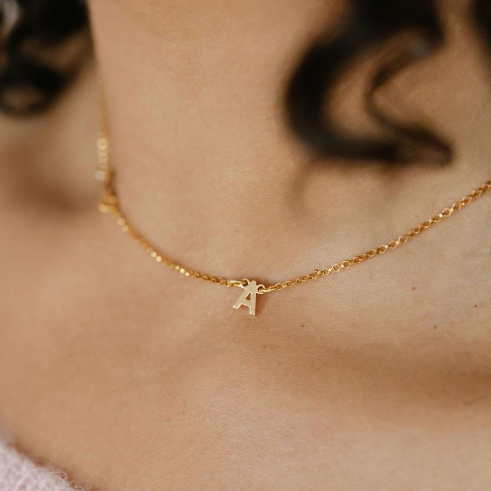 Solid gold letter necklace close up of letter A 