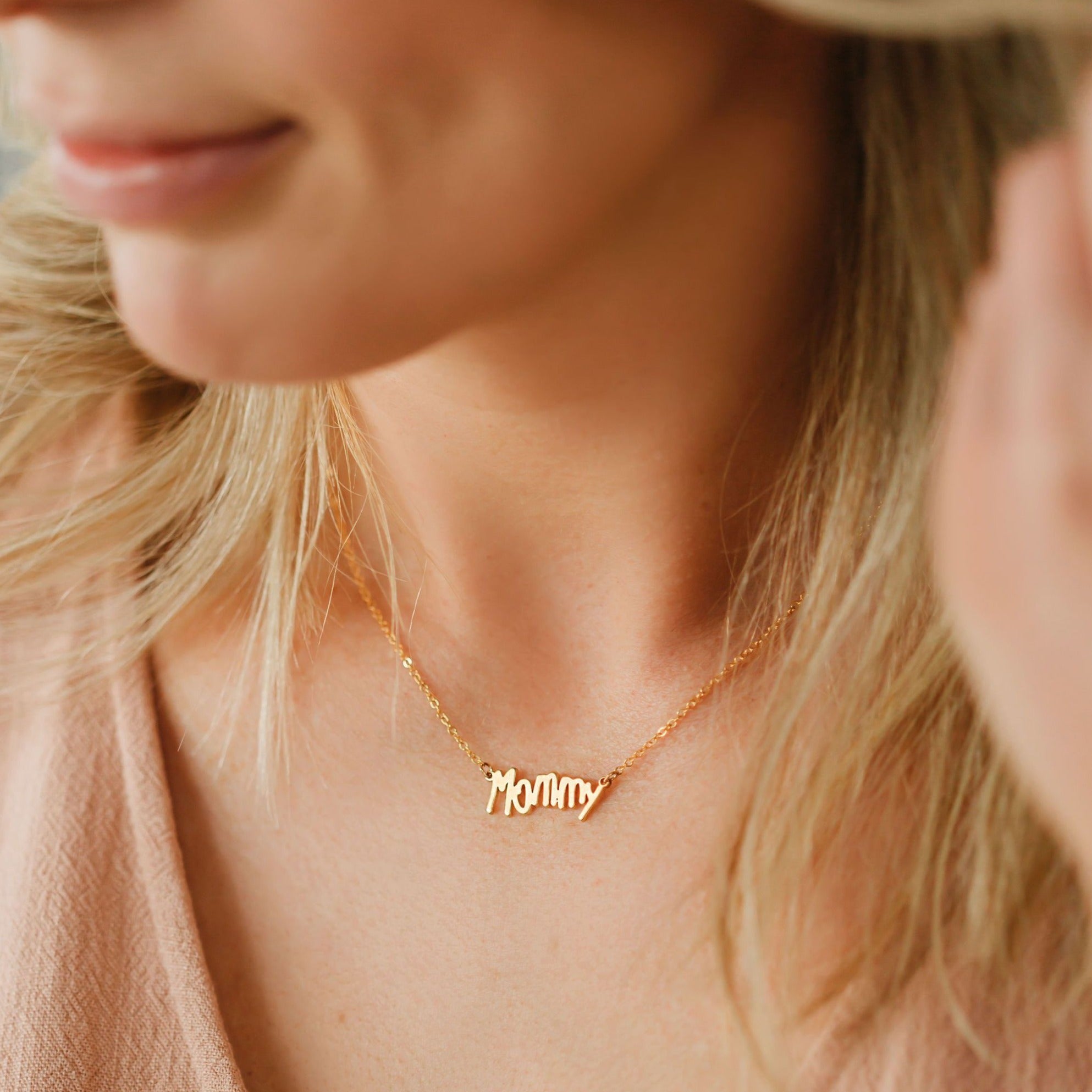 Women wearing a necklace from her daughters handwriting