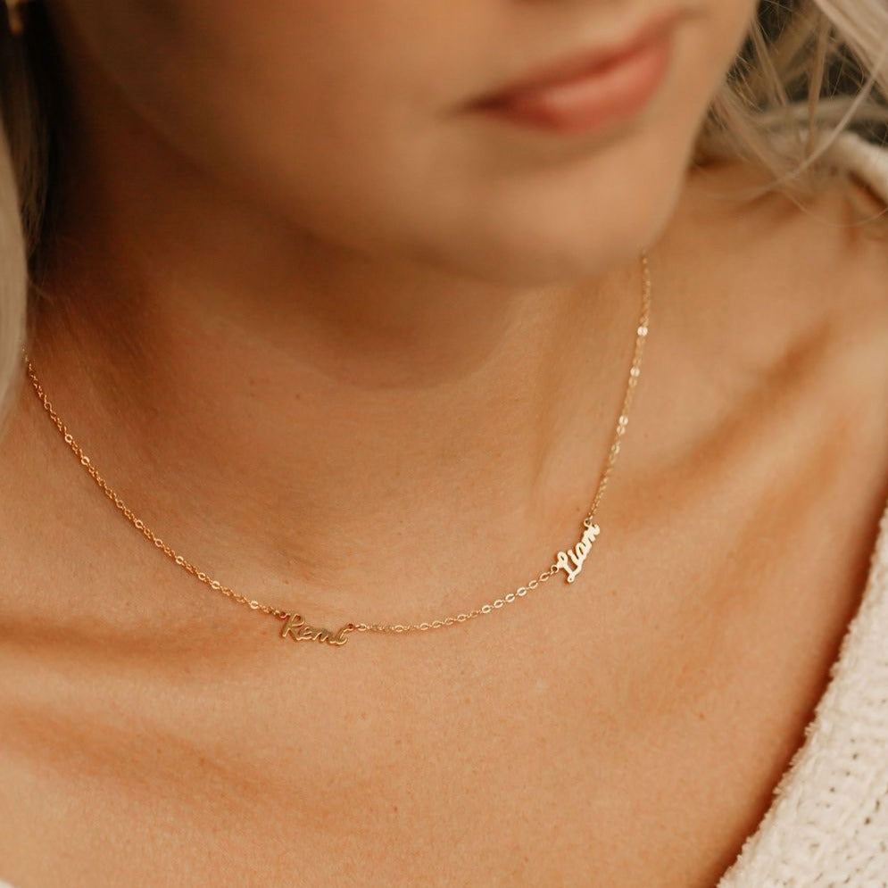 Mom wearing gold necklace with her kids names 
